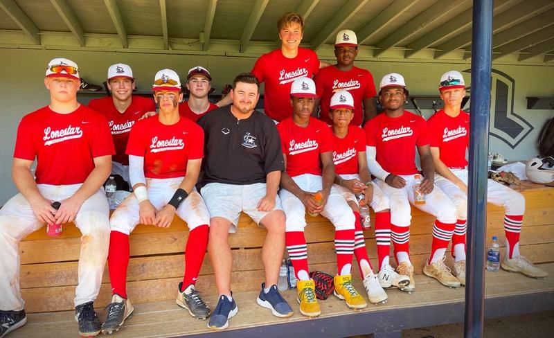 A Windmill team in red jerseys in the dugout